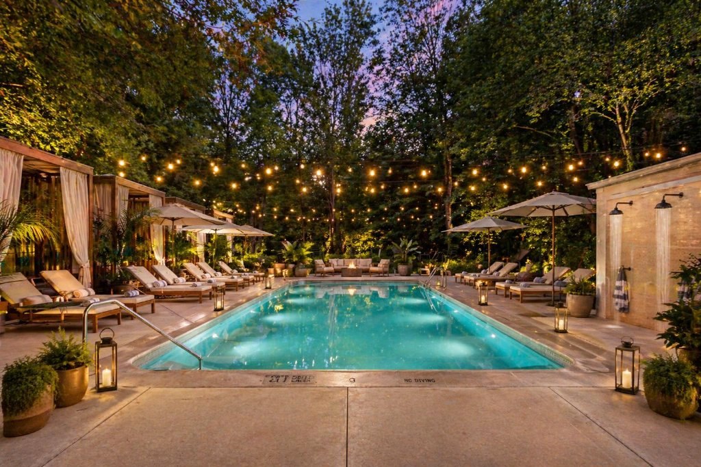 The outdoor pool at dusk, string lights above